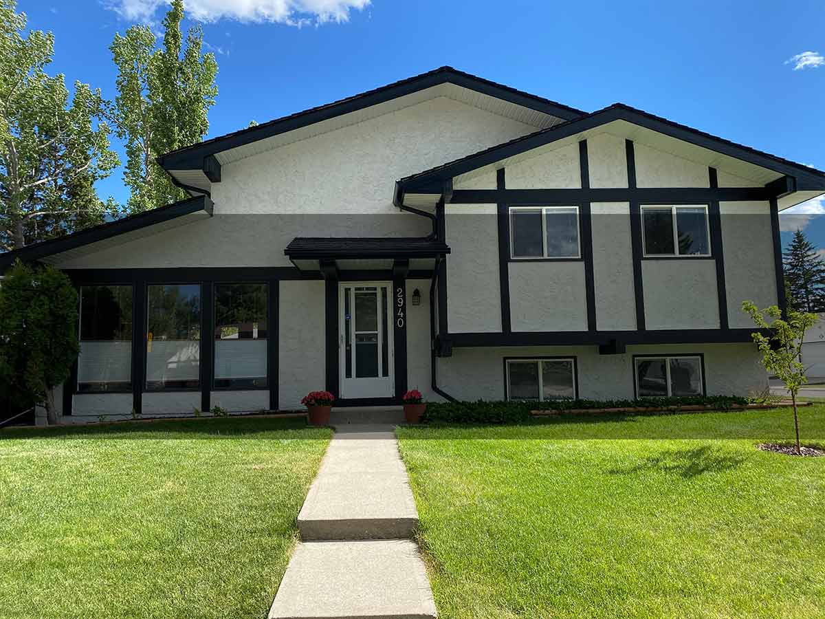 Repainted stucco bungalow exterior in Calgary